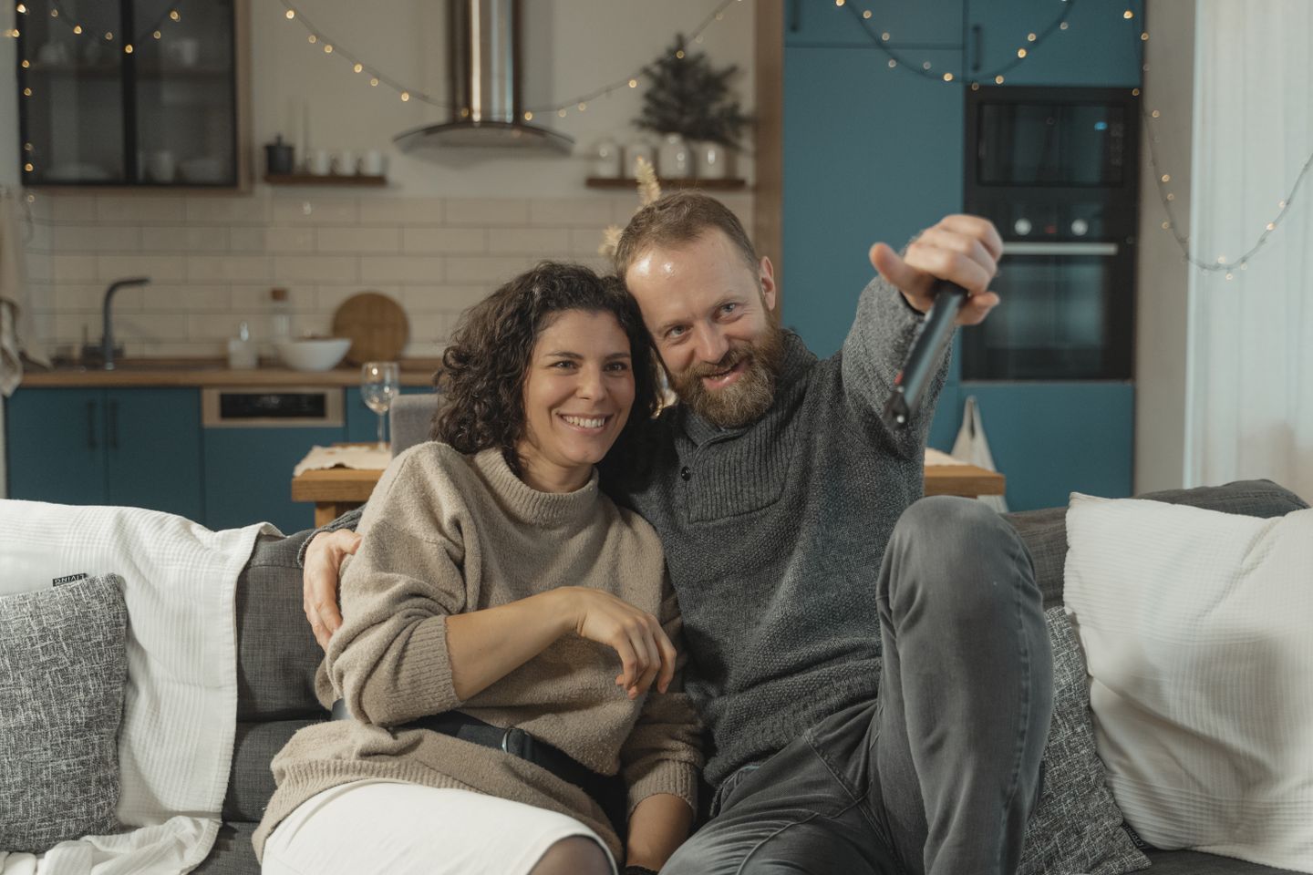 Couple relaxing on a sofa and watching television together