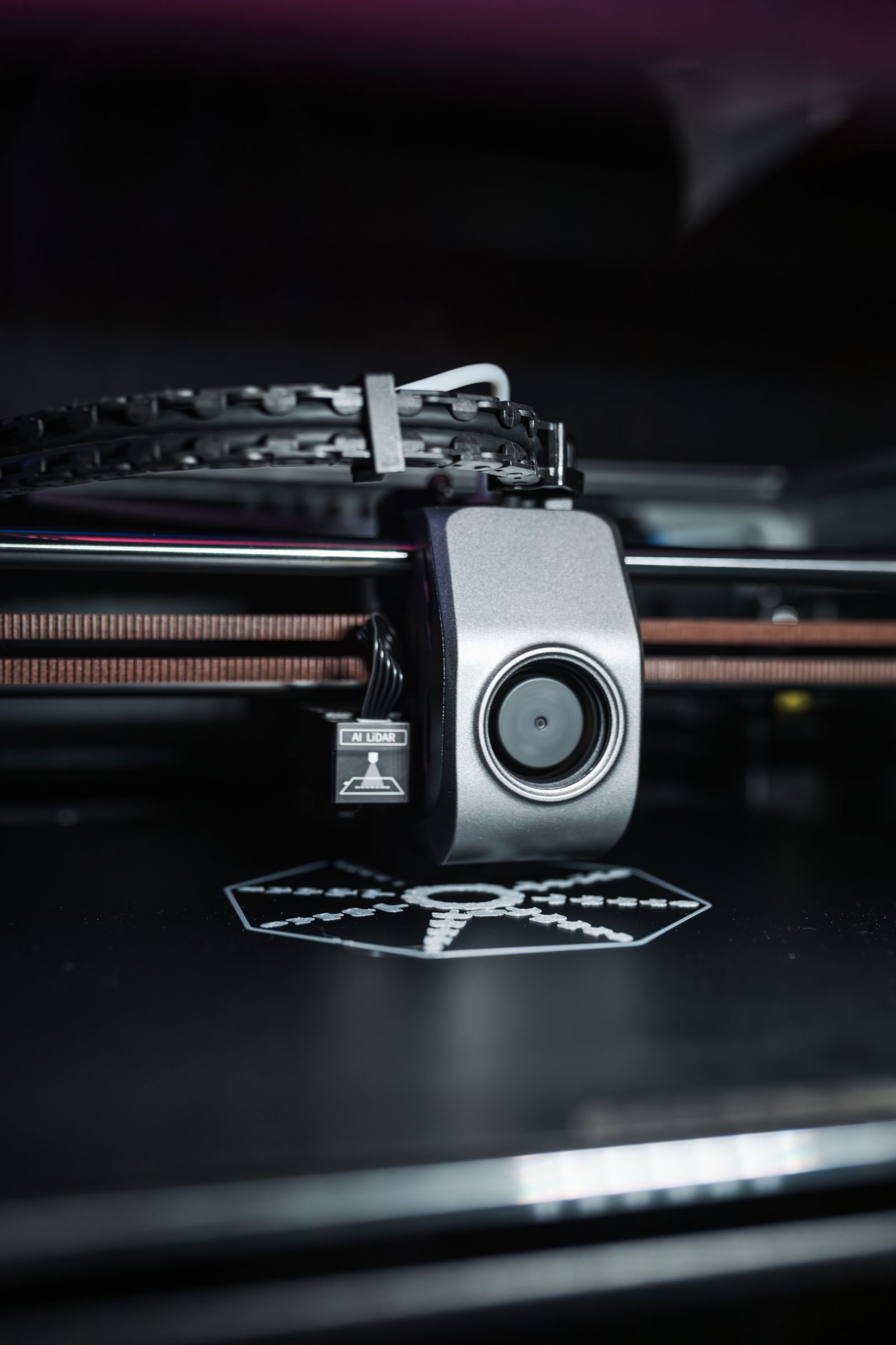 Close view of an FDM 3D printer extruder building a plastic part