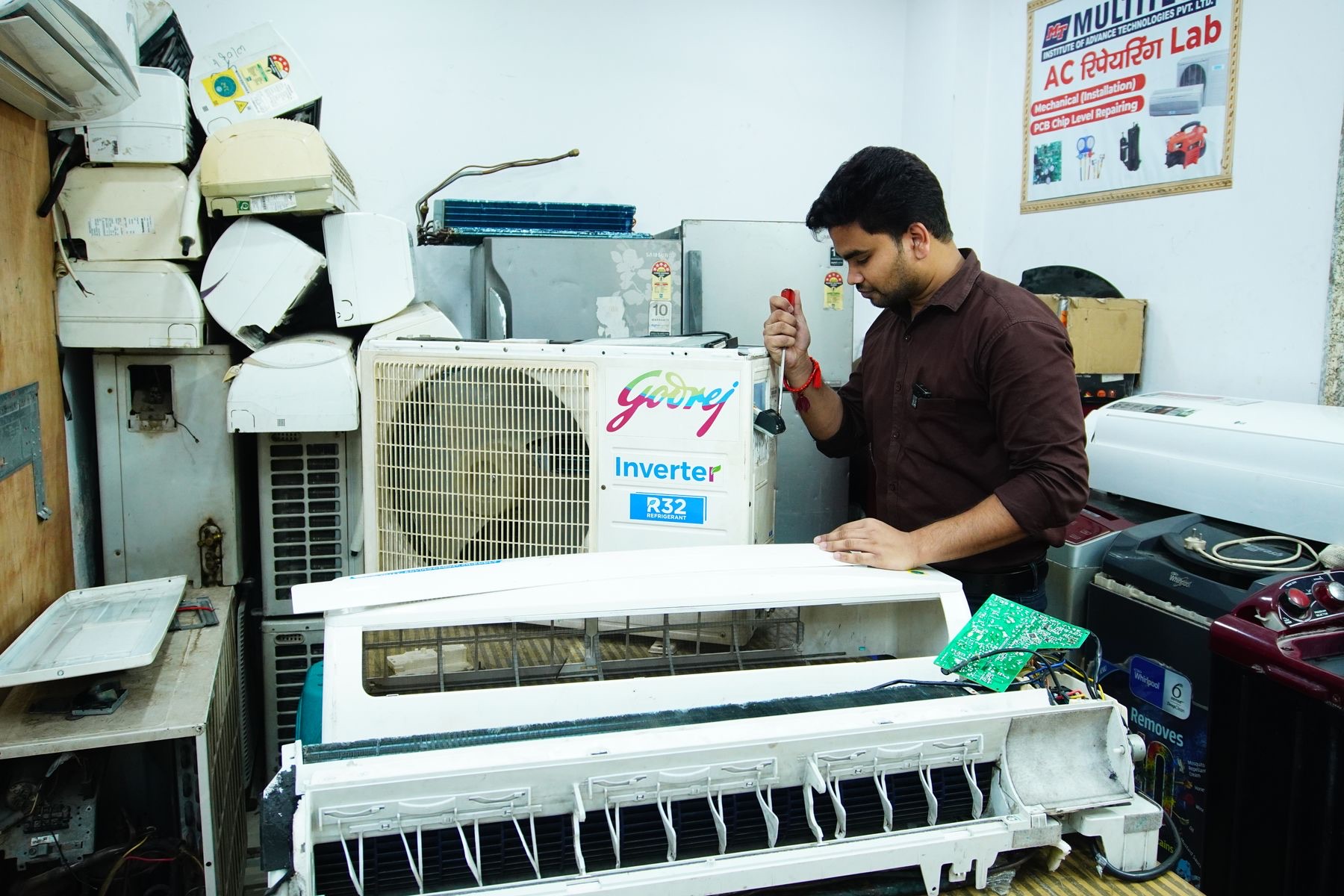 Technician working on the indoor unit of an air conditioner
