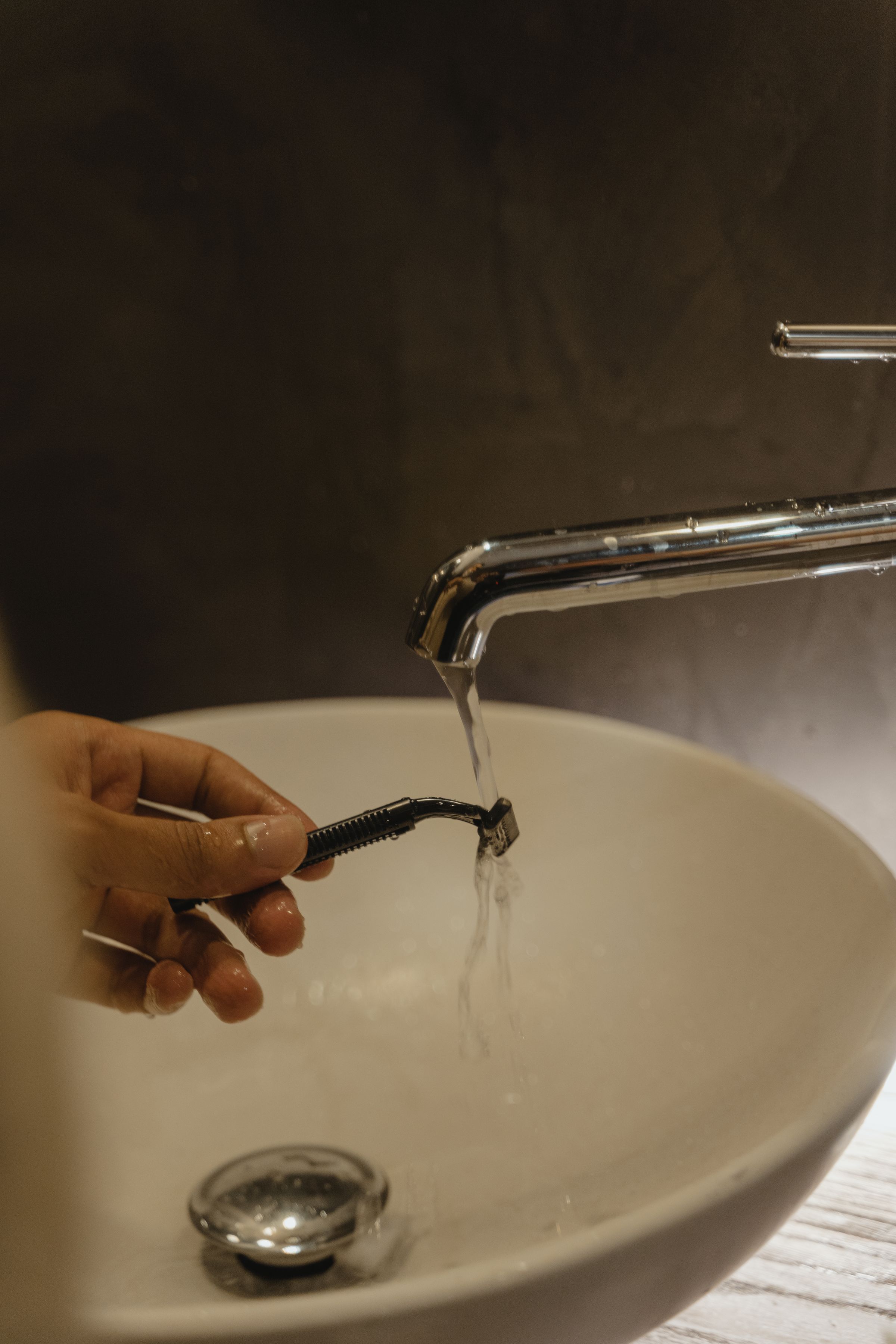 Hand rinsing an electric shaver safely under running water