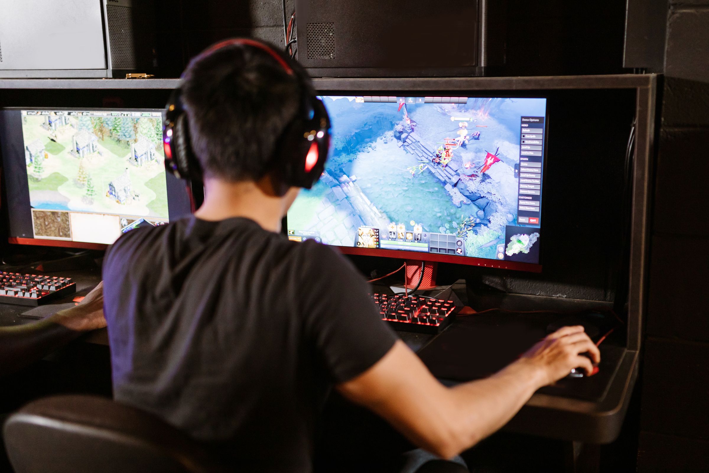Gamer using dual monitors during a fast-paced computer game