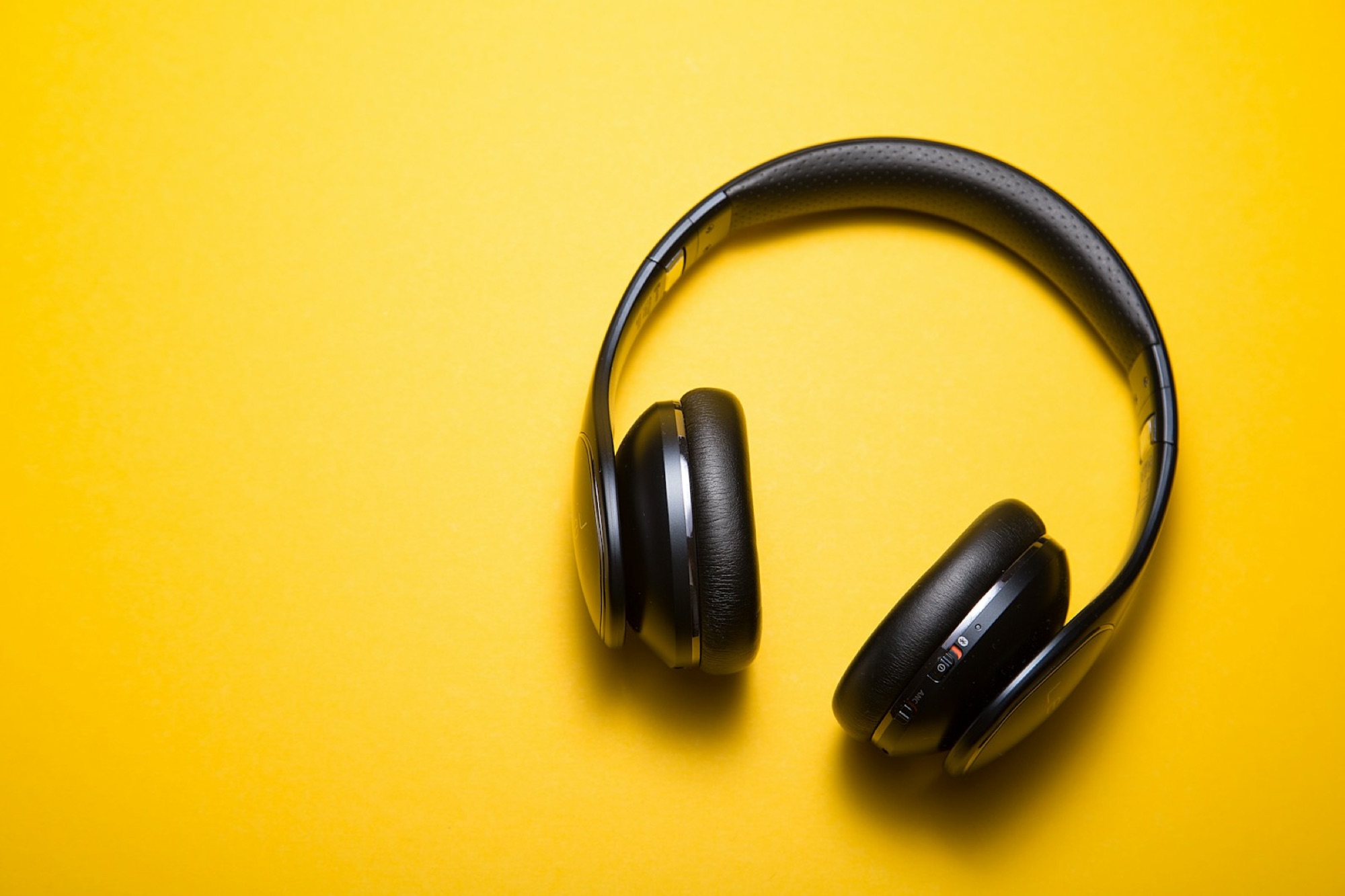 Over-ear noise-cancelling headphones beside in-ear ear tips