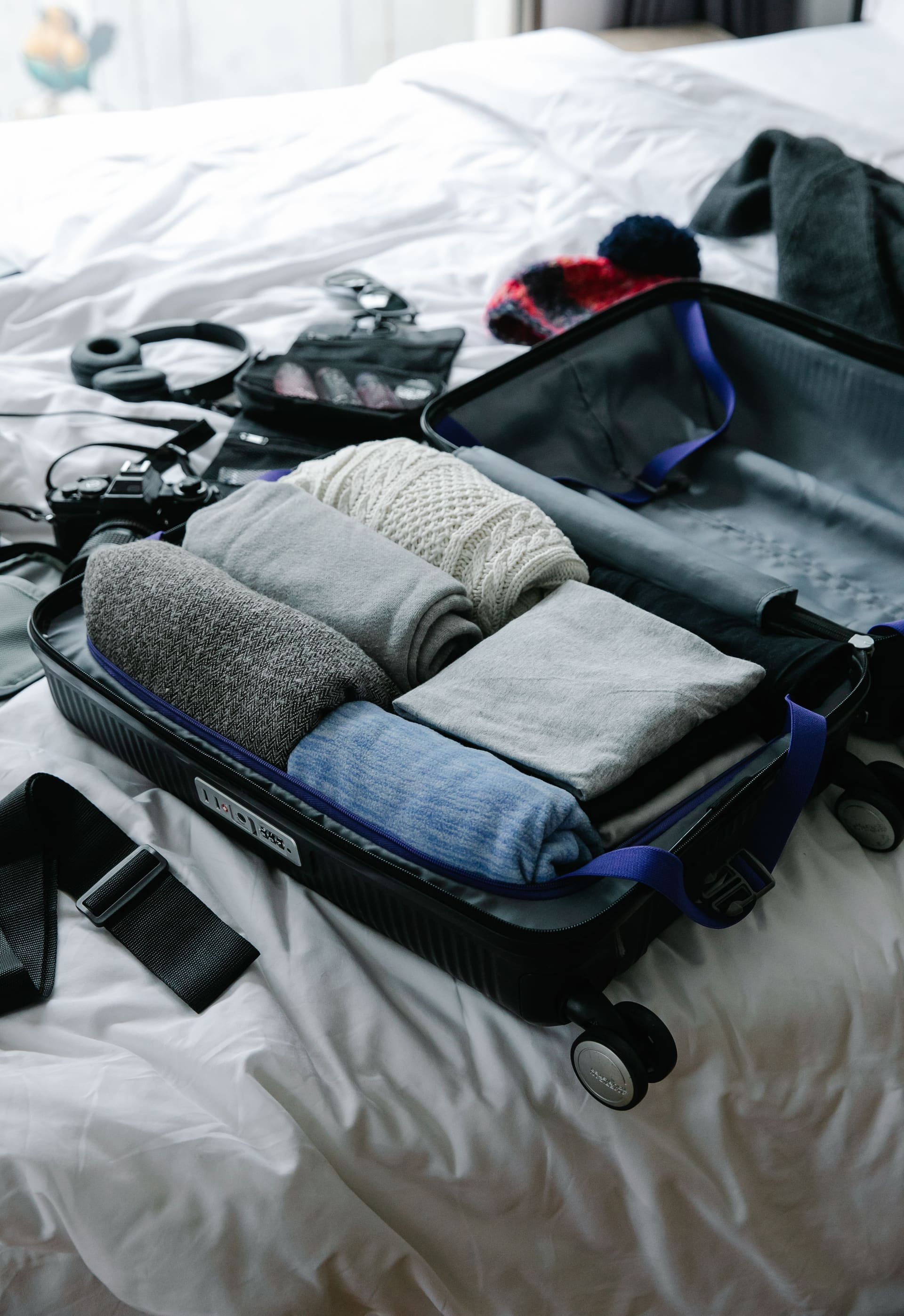 Open suitcase filled with neatly folded clothes ready for a trip