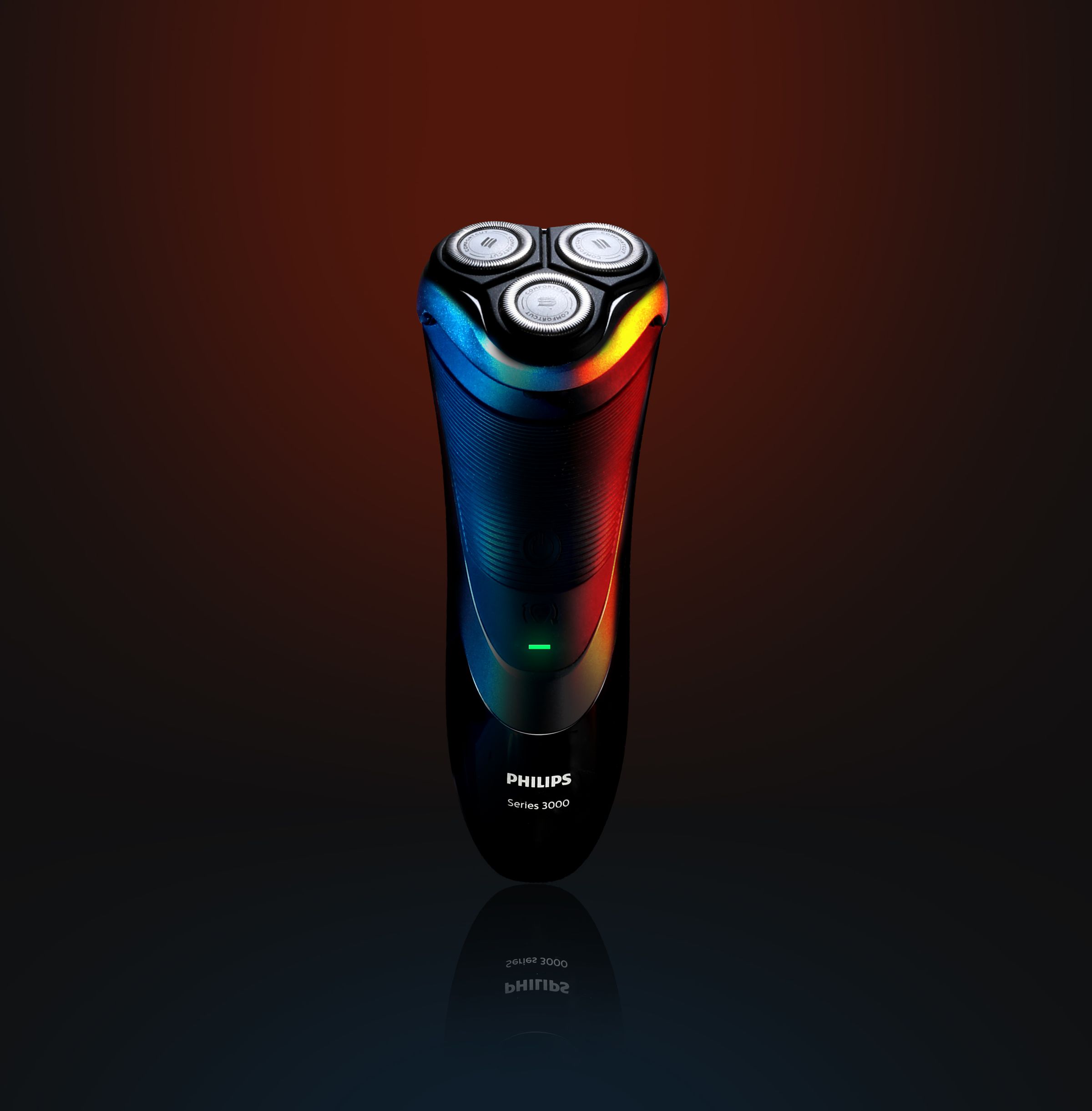 Three-head rotary electric shaver photographed in a studio