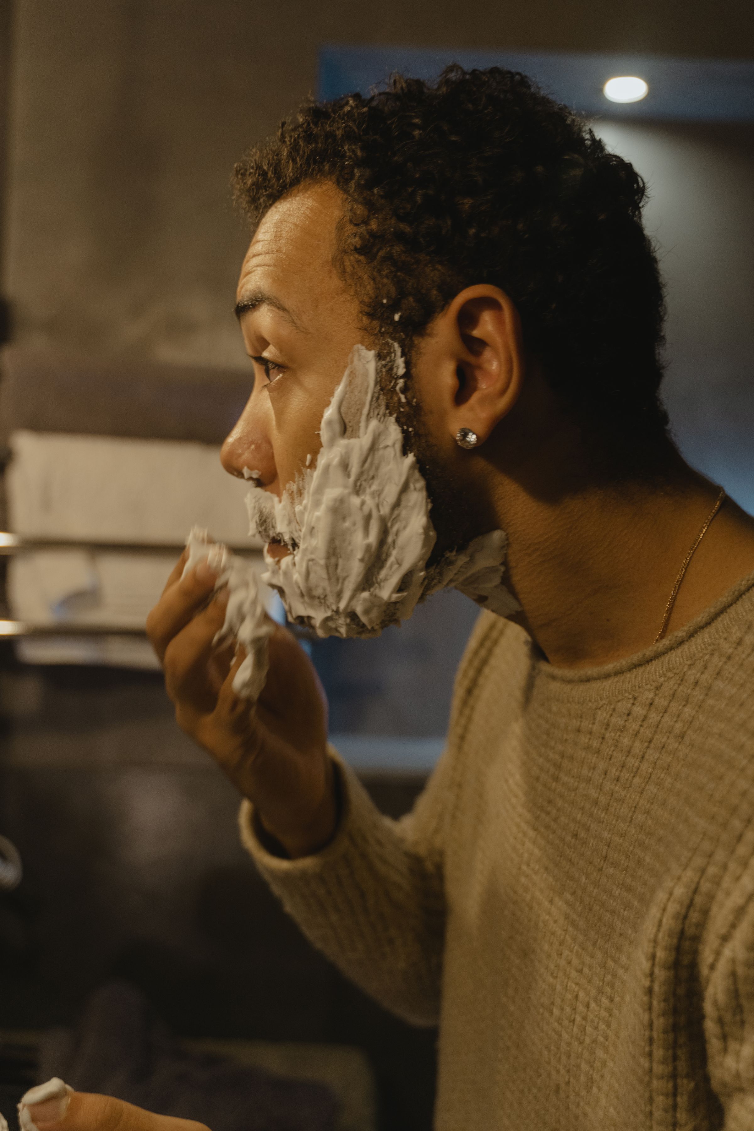 Man applying shaving cream to his face before shaving