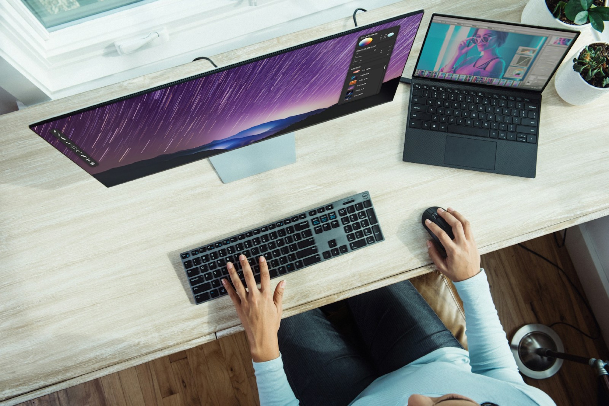 Person adjusting an electric standing desk to elbow height