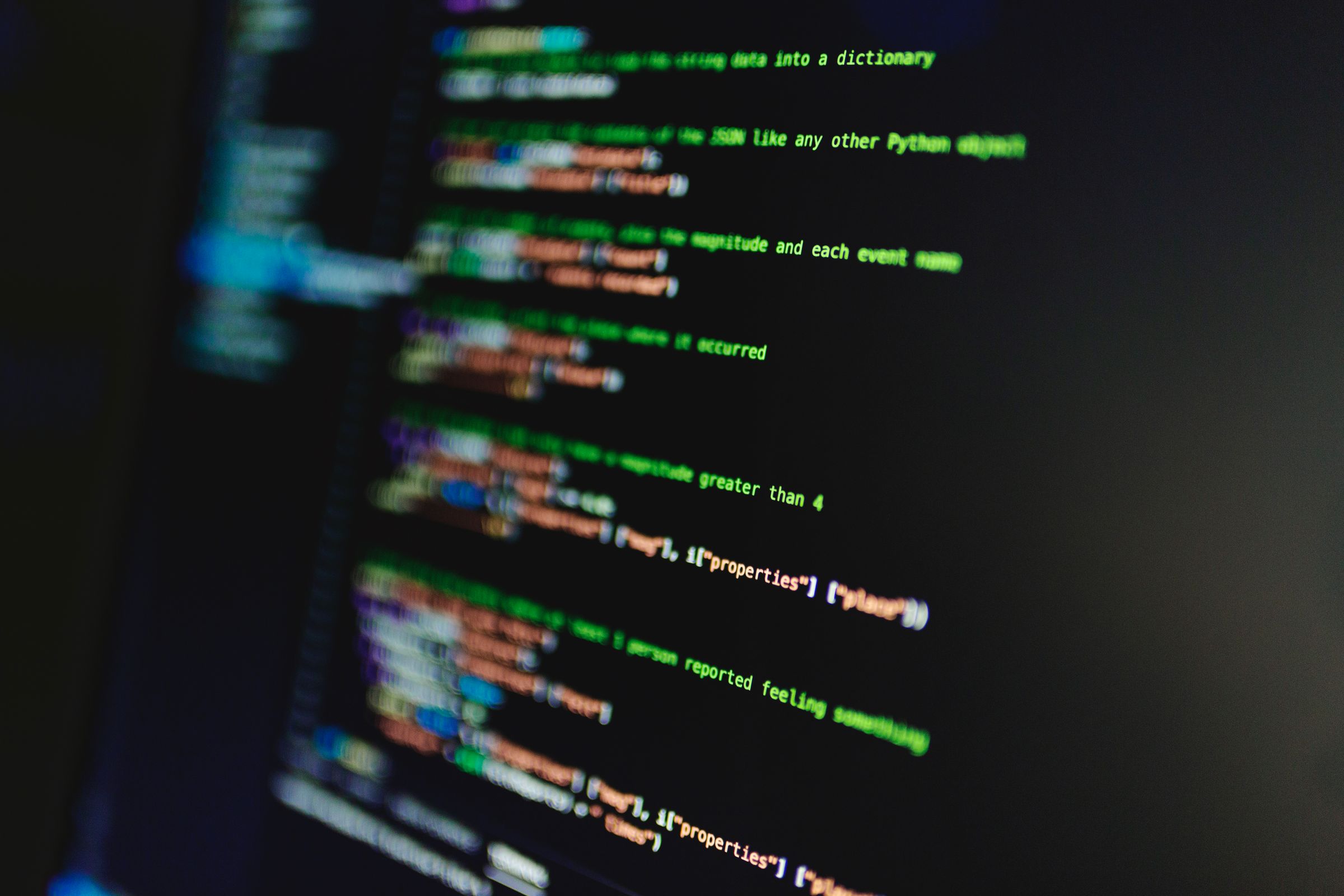 Blurred lines of colorful code displayed on a computer monitor
