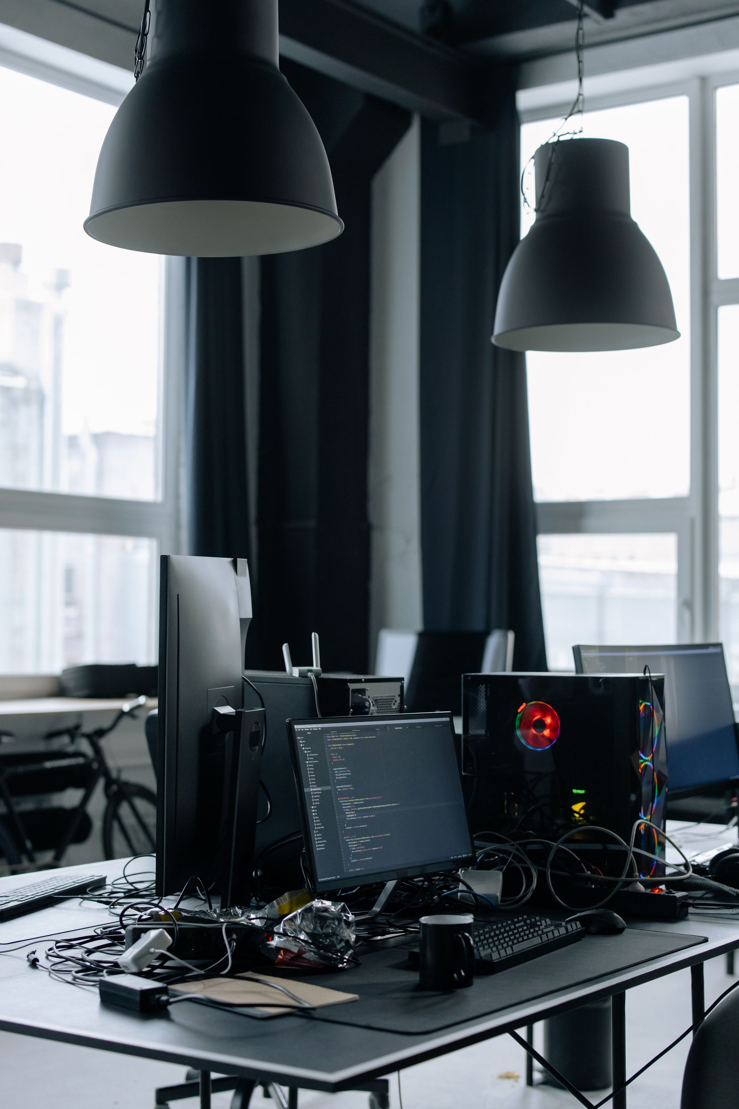 Modern desk with multiple computer monitors and connected equipment