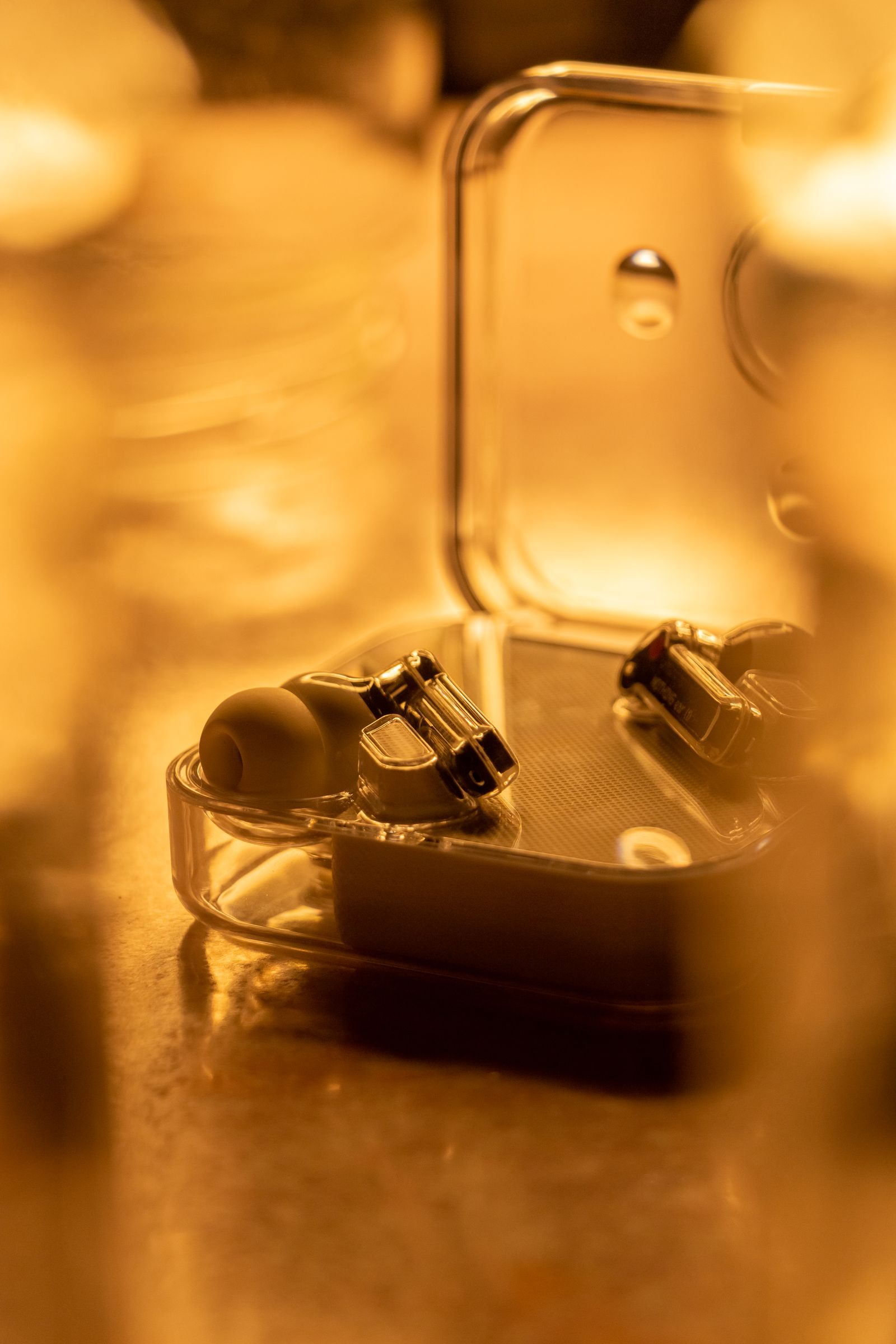 Wireless earbuds resting inside a transparent charging case